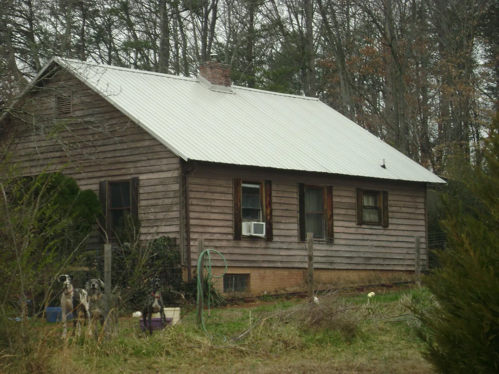 White metal roof on an old wood sided farmhouse, from a Metal Roof Installation job in North Hampton
